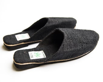 May include: Two pairs of black hemp slippers with a hemp leaf logo and the text "PURE HEMP" and "TREE FREE NATURAL".