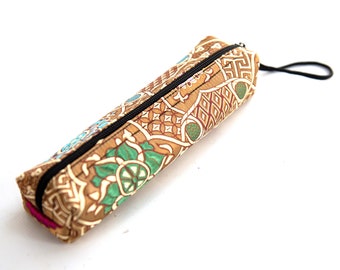 May include: A brown pencil case with a zipper closure and a colorful floral pattern. The case has a small loop handle.