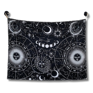 Front view of black and white celestial zodiac tapestry featuring moon phases, constellations, star charts, and vintage style sun moon faces.