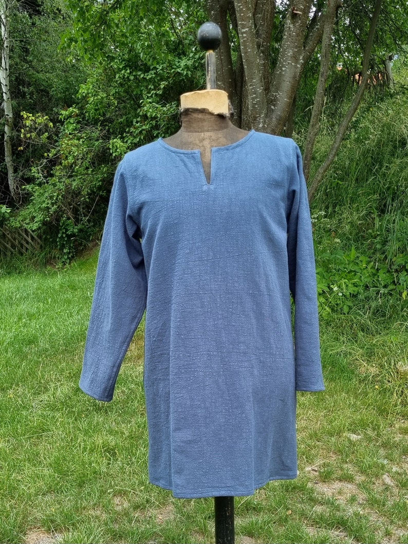 May include: A long-sleeved, light blue tunic with a V-neck.