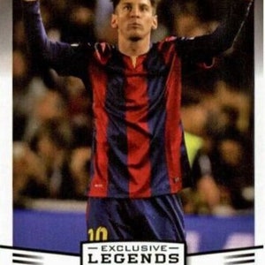 May include: A trading card featuring Lionel Messi in a red and blue striped jersey, with his arms raised. The card includes the text "EXCLUSIVE LEGENDS EDITION" and "FORWARD". The background is blurred, suggesting a stadium setting.