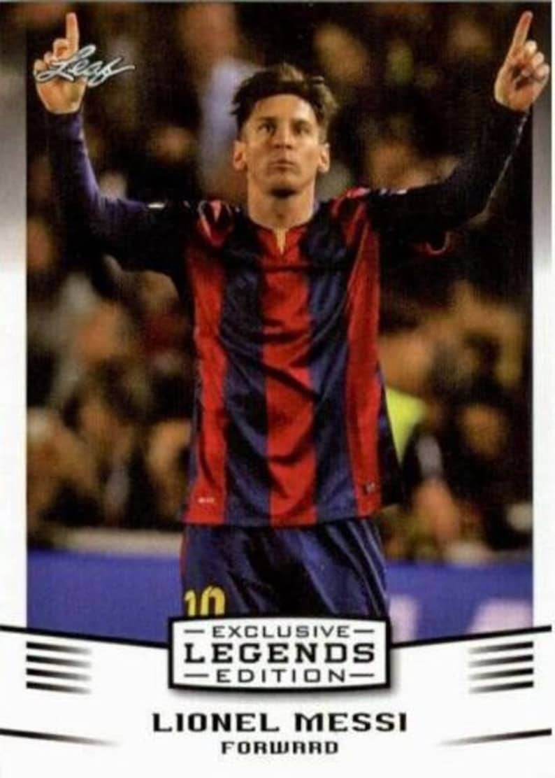 May include: A trading card featuring Lionel Messi in a red and blue striped jersey, with his arms raised. The card includes the text "EXCLUSIVE LEGENDS EDITION" and "FORWARD". The background is blurred, suggesting a stadium setting.