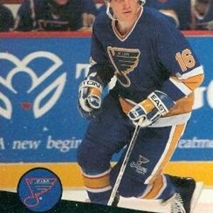 May include: A hockey trading card featuring Brett Hull, a player for the St. Louis Blues, wearing a blue and yellow jersey with the number 16. The card is from the 1991-92 Pro Set series.