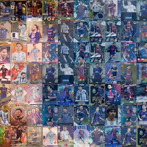 May include: A collection of soccer trading cards featuring Lionel Messi in various poses and team uniforms. The cards display vibrant colors and include text such as "Messi", "FC Barcelona", and card numbers. The cards are arranged in a grid.