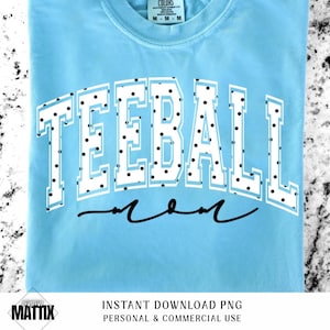 May include: Light blue t-shirt with the word "TEEBALL" in white block letters with black polka dots. Below the word is the word "mom" in a cursive font. The shirt is a medium size.