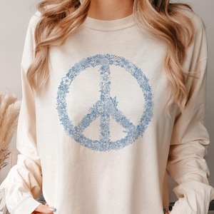 long sleeve ivory shirt with a boho navy floral peace sign