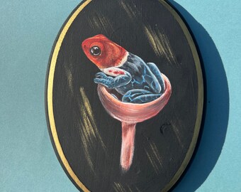 Ranitomeya fantastica sitting in a mushroom acrylic painting on a wooden plaque