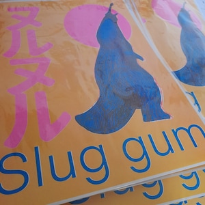May include: A blue and pink illustration of a slug with the text "slug gum" printed on a yellow background.
