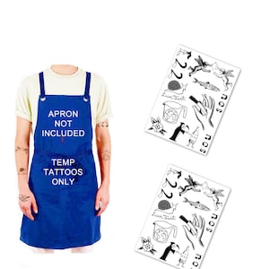 May include: A blue apron with the white text APRON NOT INCLUDED TEMP TATTOOS ONLY and two sheets of black and white temporary tattoos featuring designs of cherubs, a snail, a fish, a hand, a globe, a flower, and a grim reaper.