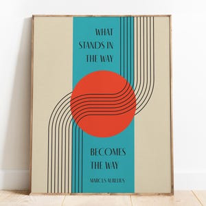 May include: A motivational quote by Marcus Aurelius, "What stands in the way becomes the way", is displayed on a beige background with a teal blue stripe and a red circle with black lines.