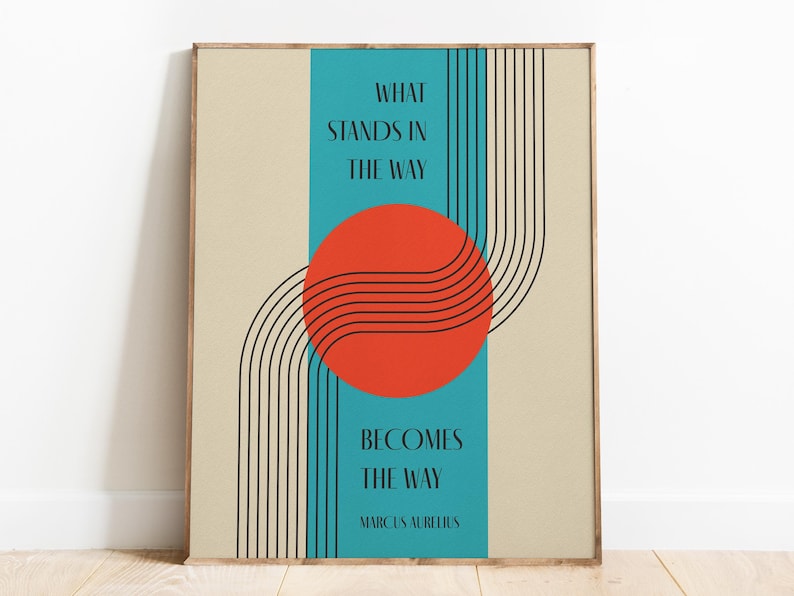 May include: A motivational quote by Marcus Aurelius, "What stands in the way becomes the way", is displayed on a beige background with a teal blue stripe and a red circle with black lines.