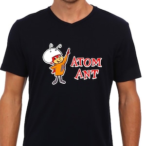 May include: A black t-shirt with a cartoon ant wearing a helmet and the words "ATOM ANT" printed on the front.