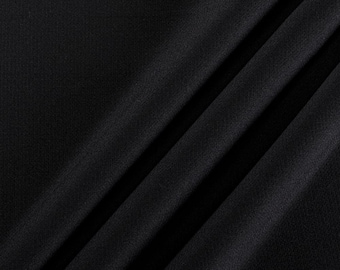 May include: Black fabric with a smooth, slightly textured surface. The fabric is folded in a diagonal pattern. The word "PROCOOL" is printed in red and white letters in the lower right corner of the image.