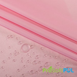 May include: Pink fabric with a water-resistant finish. Water droplets bead up on the surface of the fabric.