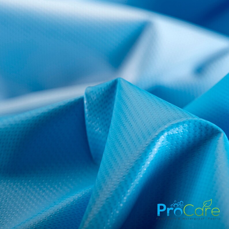 May include: Close-up of a bright blue fabric with a textured surface. The fabric is folded and has a slight sheen. The text "ProCare" is visible in the lower right corner of the image.