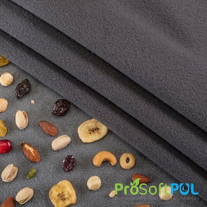 May include: A close-up of a gray fleece fabric with a variety of nuts, dried fruit, and cereal scattered on a gray surface. The fabric is folded in thirds and the text "ProSoftPUL" is visible in the lower right corner.