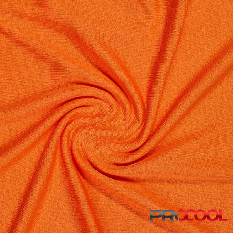 May include: A close-up of a bright orange fabric with a smooth, even texture. The fabric is folded and twisted, creating a swirling pattern.