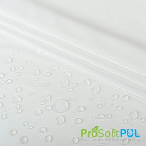 May include: White fabric with water droplets on it. The fabric is smooth and has a slight sheen. The text "ProSoftPUL Eco-friendly Waterproof Fabrics" is at the bottom of the image.