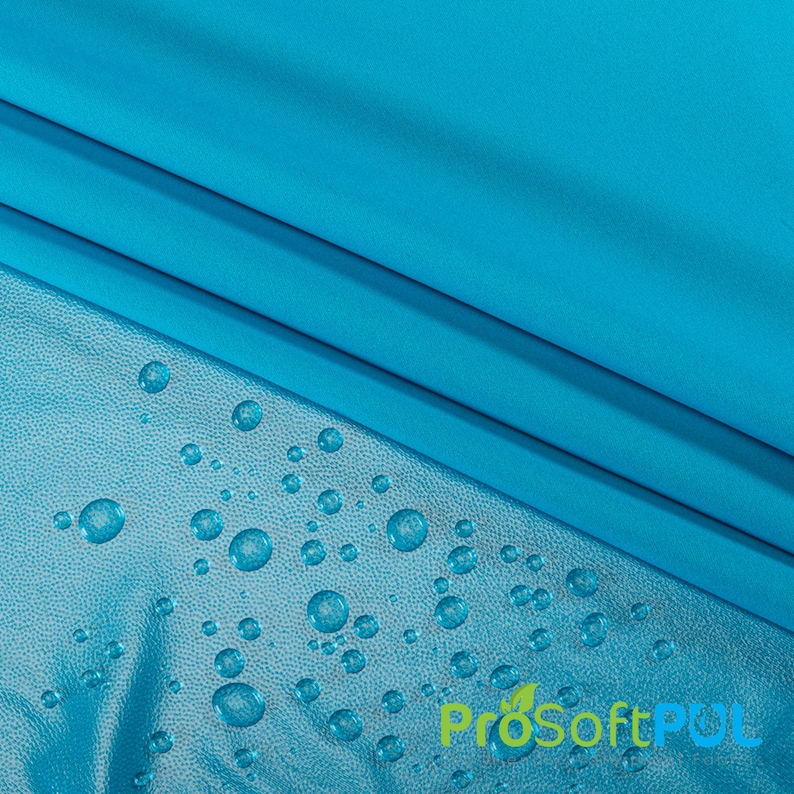 May include: A close-up of a turquoise fabric with water droplets on a textured surface. The fabric is water-resistant and has a ProSoftPUL logo.
