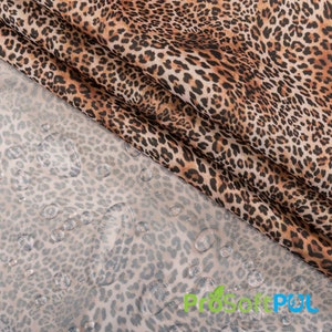 May include: A close-up of a brown and black leopard print fabric with water droplets on top of a similar but lighter colored fabric. The fabric is waterproof and has a ProSoftPUL logo in the bottom right corner.