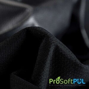 May include: Close-up of black fabric with a textured weave. The fabric is folded to show its texture. The text "ProSoftPUL Eco-friendly Waterproof Fabrics" is visible at the bottom of the image.