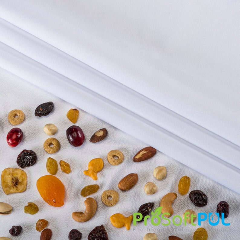 May include: A white surface with a variety of dried fruits, nuts, and cereal pieces. The text "ProSoftPUL Eco friendly textiles" is visible in the lower right corner of the image.