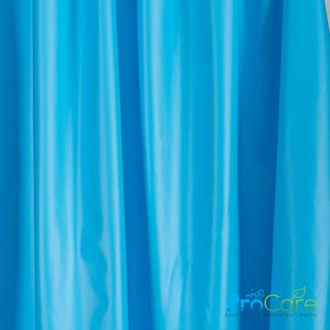 May include: A close-up of a bright blue fabric with a subtle sheen. The fabric is smooth and has a slight wrinkle. The text "ProCare Food Safe Waterproof Fabric" is visible in the bottom right corner of the image.