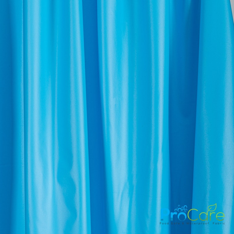 May include: A close-up of a bright blue fabric with a subtle sheen. The fabric is smooth and has a slight wrinkle. The text "ProCare Food Safe Waterproof Fabric" is visible in the bottom right corner of the image.