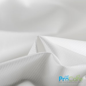 May include: Close-up of white, textured fabric. The fabric is folded in a triangular shape, showing the smooth, white underside. The fabric is labeled "ProCare Food Safe & Waterproof Fabric".