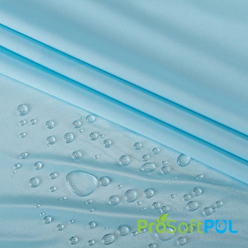 May include: A light blue fabric with water droplets on the surface. The fabric is smooth and has a slight sheen. The water droplets are round and clear. The text "ProSoftPUL" is visible in the lower right corner of the image.