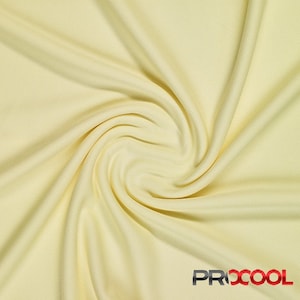 May include: A close-up of a pale yellow fabric with a soft, smooth texture. The fabric is draped and folded, creating a swirling pattern.