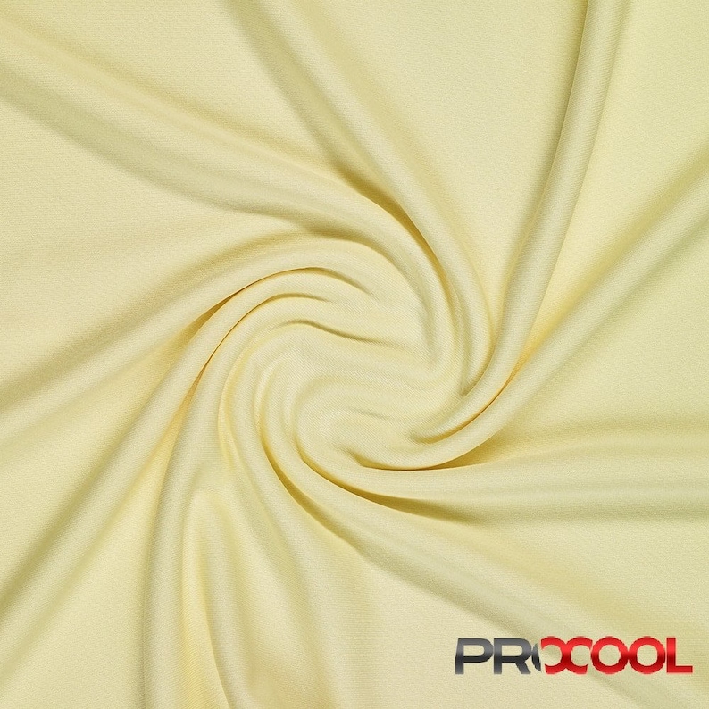 May include: A close-up of a pale yellow fabric with a soft, smooth texture. The fabric is draped and folded, creating a swirling pattern.