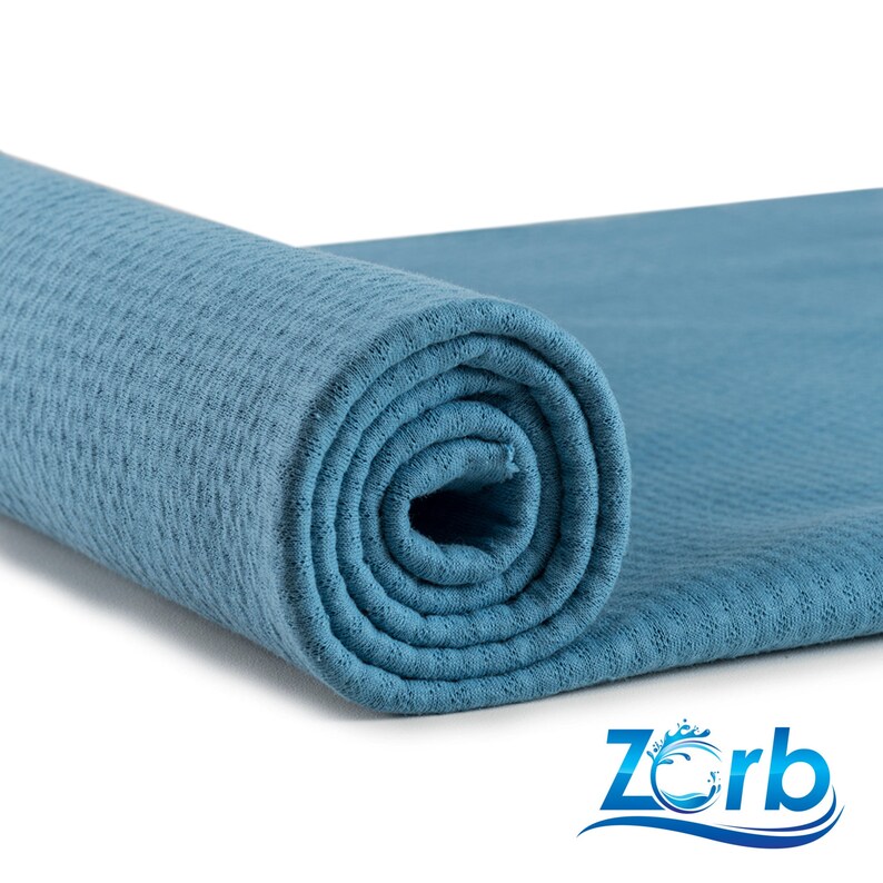 May include: A rolled up blue waffle weave bath towel. The towel is made of a soft, absorbent material and is perfect for drying off after a shower or bath.