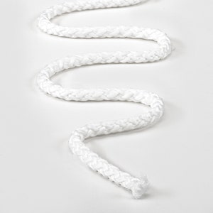 May include: White braided rope, coiled and laid out on a white surface.