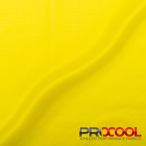 May include: Bright yellow fabric with a subtle texture. The fabric is smooth and has a slight sheen. The fabric is folded in the center, creating a soft curve. The fabric is labeled "PRXCOOL ATHLETIC PERFORMANCE FABRICS".