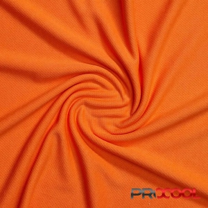 May include: Close-up of a bright orange fabric with a textured, mesh-like pattern. The fabric is folded and twisted, showing its flexibility and drape.