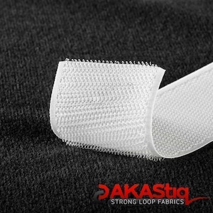 May include: White hook and loop tape, also known as Velcro, with a close-up of the hook side. The tape is folded over on itself, showing the texture of the fabric.