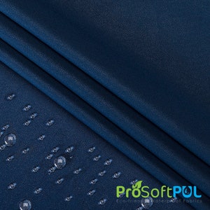 May include: Close-up of a dark blue fabric with water droplets on the surface. The fabric is textured and has a subtle sheen. The text "ProSoftPUL Eco-friendly Waterproof Fabrics" is visible in the lower right corner.