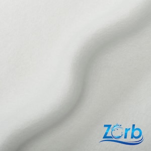 May include: White fabric with a slight wave pattern. The fabric is smooth and soft. The word "Zorb" is printed in blue with a wave design.