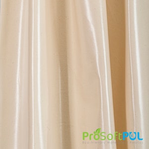 May include: Close-up of a smooth, off-white fabric with a subtle shimmer. The fabric has a slightly textured surface and is draped in soft folds.