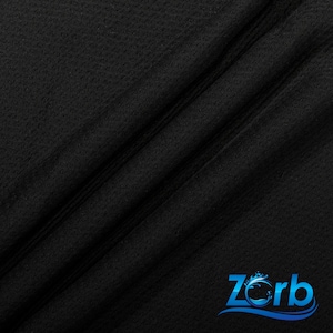 May include: Black fabric with a textured surface. The fabric is folded in half, creating a diagonal line. The Zorb logo is visible in the bottom right corner.