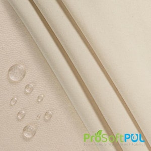 May include: Close-up of a beige fabric with water droplets on the surface. The fabric is smooth and has a subtle texture. The text "ProSoftPUL Eco-friendly Waterproof Fabrics" is visible in the bottom right corner of the image.