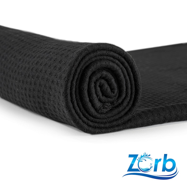 May include: A black waffle weave towel rolled up, with the brand name "Zorb" printed in blue and white on a white background.
