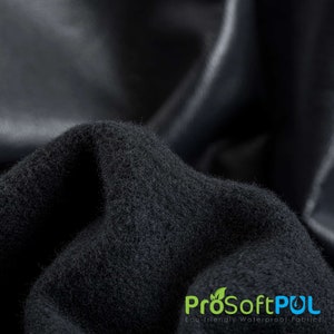 May include: Close-up of a black fabric with a soft, fuzzy texture. The fabric is folded and draped, showing its flexibility. The text "ProSoftPUL Eco-friendly Waterproof Fabrics" is visible in the lower right corner.