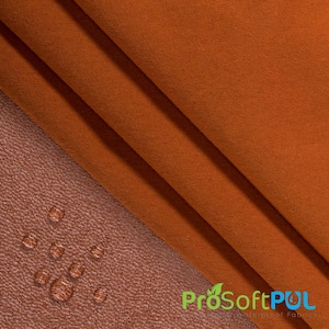 May include: Close-up of a rust-colored fabric with a soft, textured surface. The fabric is folded in thirds, creating a layered effect. The fabric is water-resistant and is labeled "ProSoftPUL" in the lower right corner.