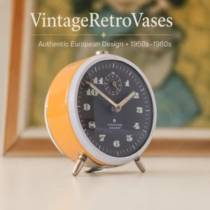 May include: A round Junghans Cavalier alarm clock with a bright yellow casing, a white bezel, and a dark face featuring white numerals and hands. The text "VintageRetroVases", "Authentic European Design", and "1950s-1980s" appears above the clock.