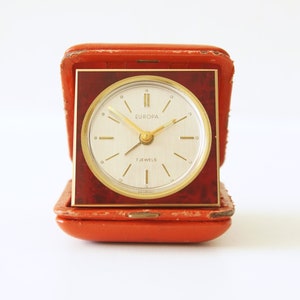 Brass Mid Century Travel Alarm clock, Red Leather case by Europa, 7 Jewels, Germany
