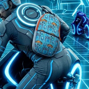 May include: A light blue backpack with an orange and blue repeating pattern of vehicles and geometric shapes, worn by a rider in a grey and blue glowing suit on a black motorcycle with bright blue light-up wheels in a digital grid environment.