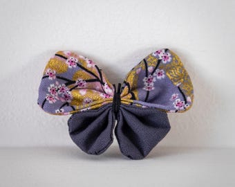 Butterfly brooch in Japanese cherry blossom fabric on a gray background