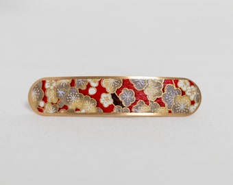 Barrette decorated with Japanese washi paper with an ecru and beige cherry blossom pattern on a red background